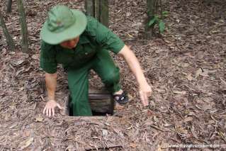 A trap door on the jungle floor leads down into the Cu Chi tunnels