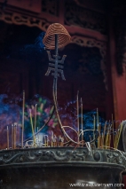 Incense sticks burn in an urn at Quan Thanh Temple