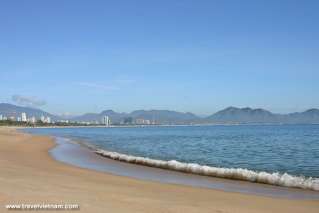 Aquamarine sea and white waves by the yellow sand beach