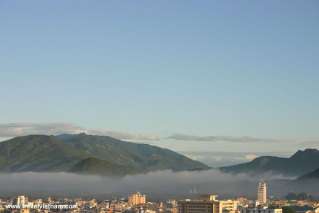 The coastal city deep in early morning mist