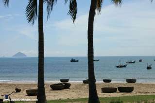 Fishing boats and bamboo baskets on beautiful beach in Nha Trang bay