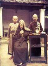 n the picture are a nun and two novices beside a prayer-book, a clock and a lily vase