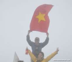 Hold aloft Vietnam National flag on Fansipan Mt